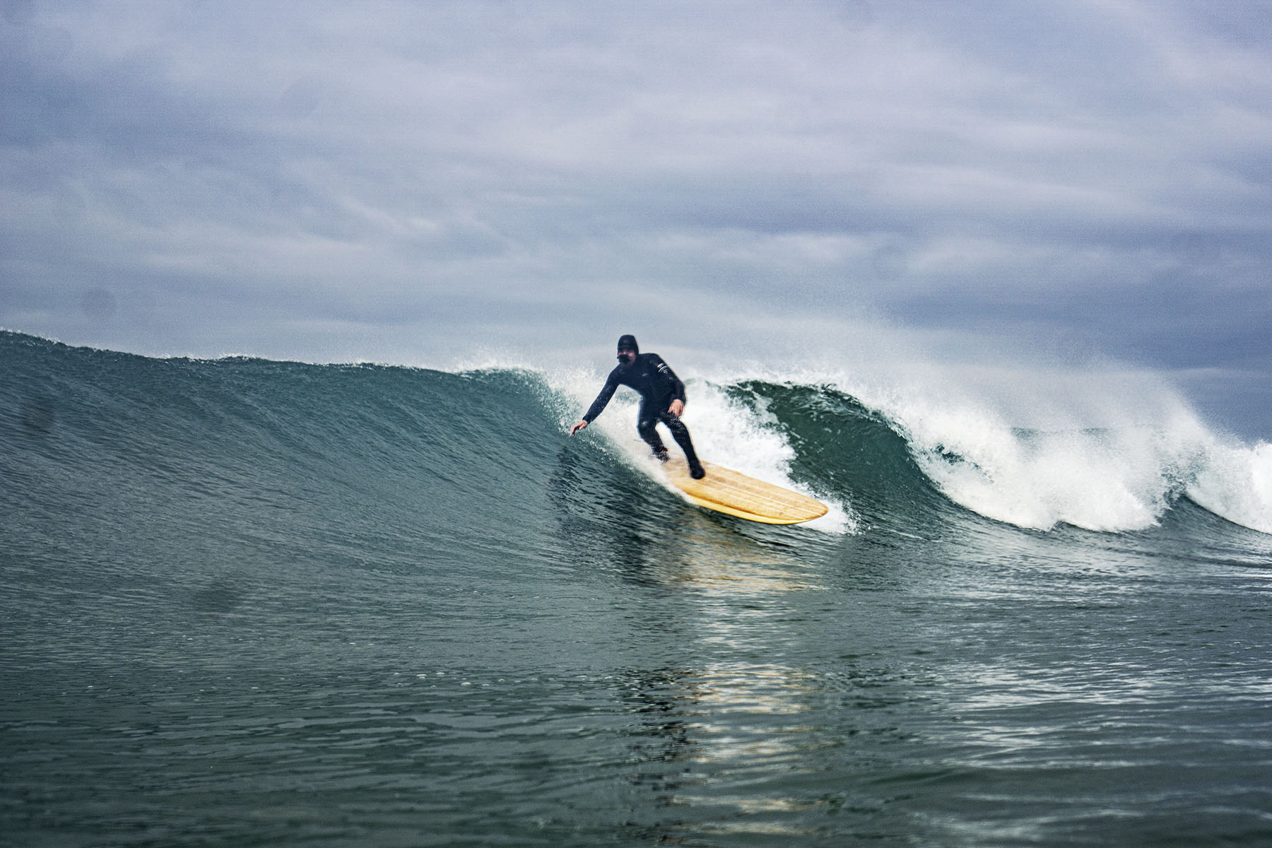James Otter surfing a sustainable, hollow wooden surfboard