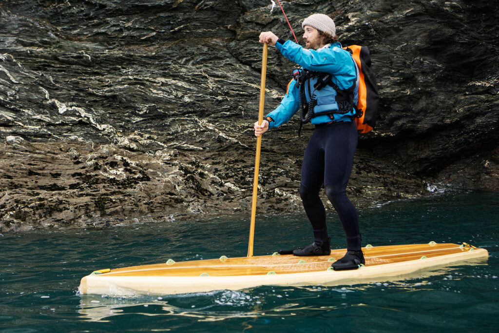 James Otter paddles one of his sustainable, wooden paddleboards.