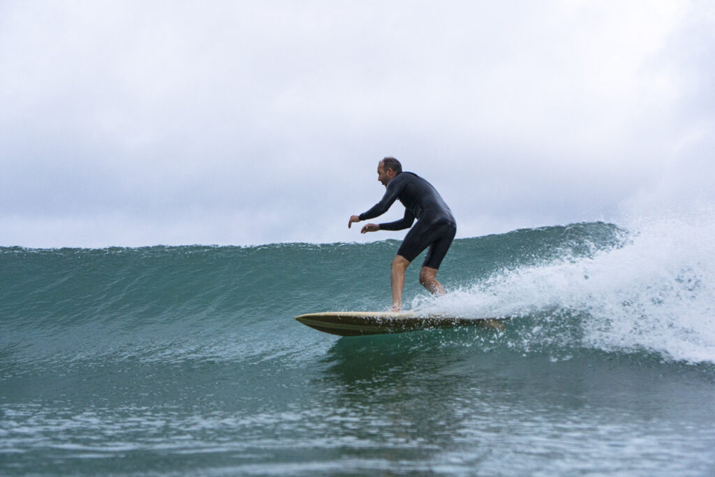 Surfing a hollow wooden surfboard, by Otter Surfboards