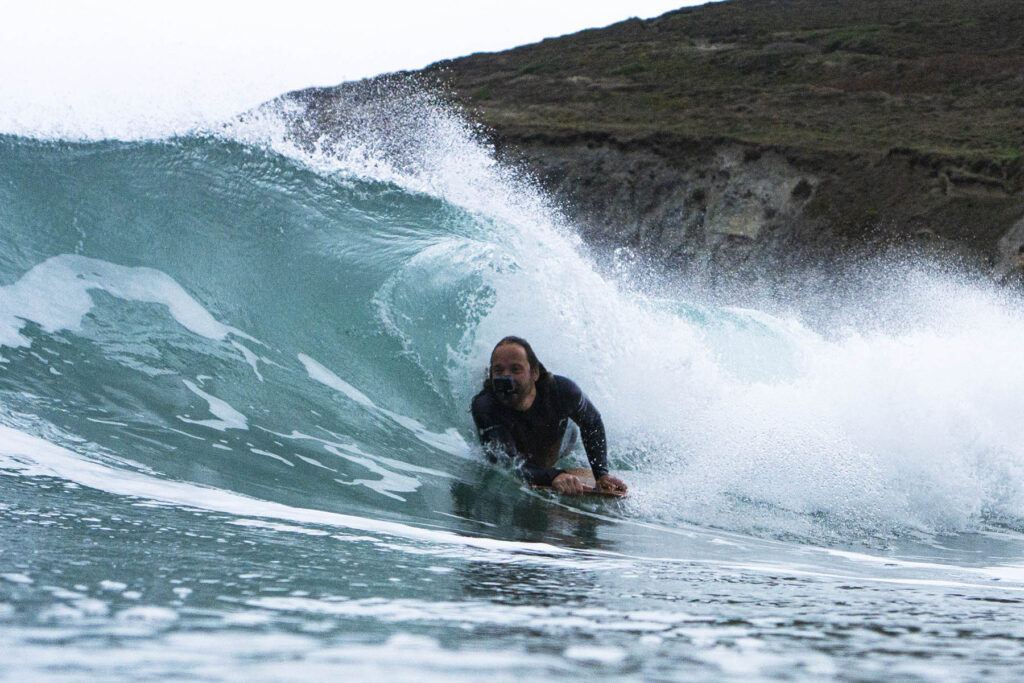 Surfing a hollow wooden surfboard, by Otter Surfboards