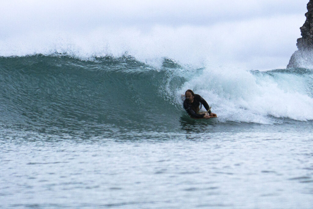 Surfing a hollow wooden surfboard, by Otter Surfboards