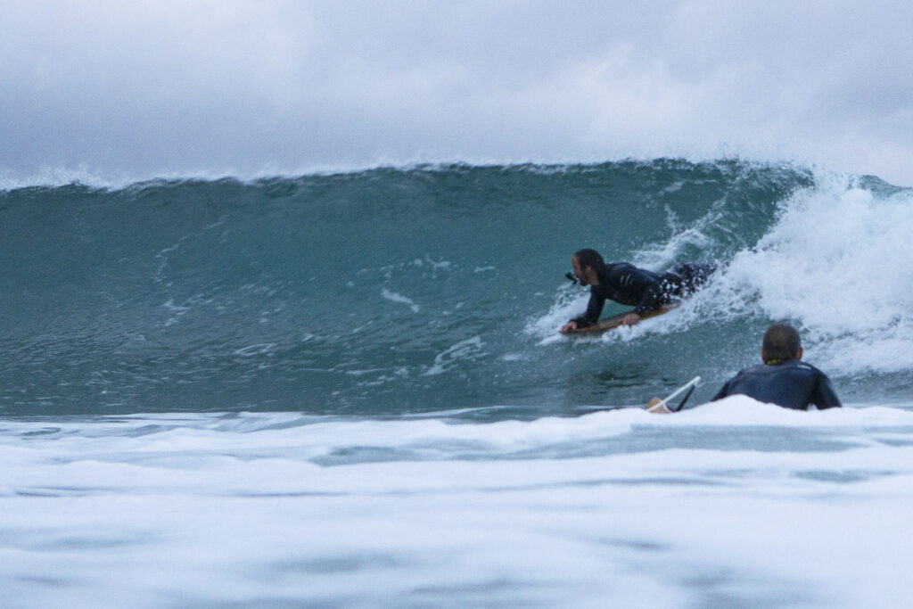 Surfing a hollow wooden surfboard, by Otter Surfboards