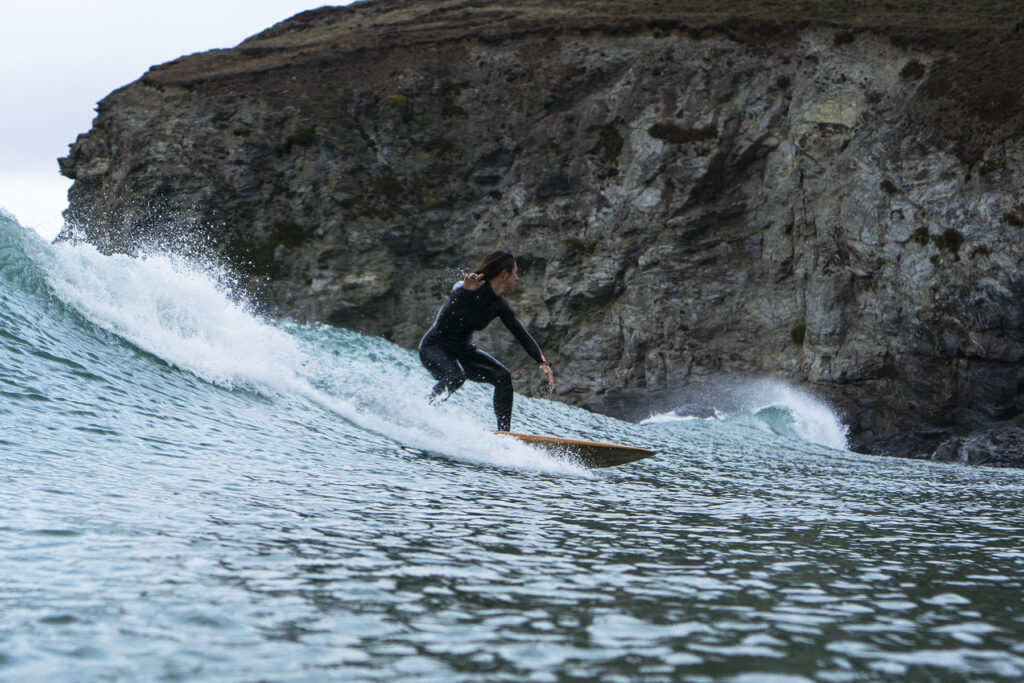 Surfing a hollow wooden surfboard, by Otter Surfboards