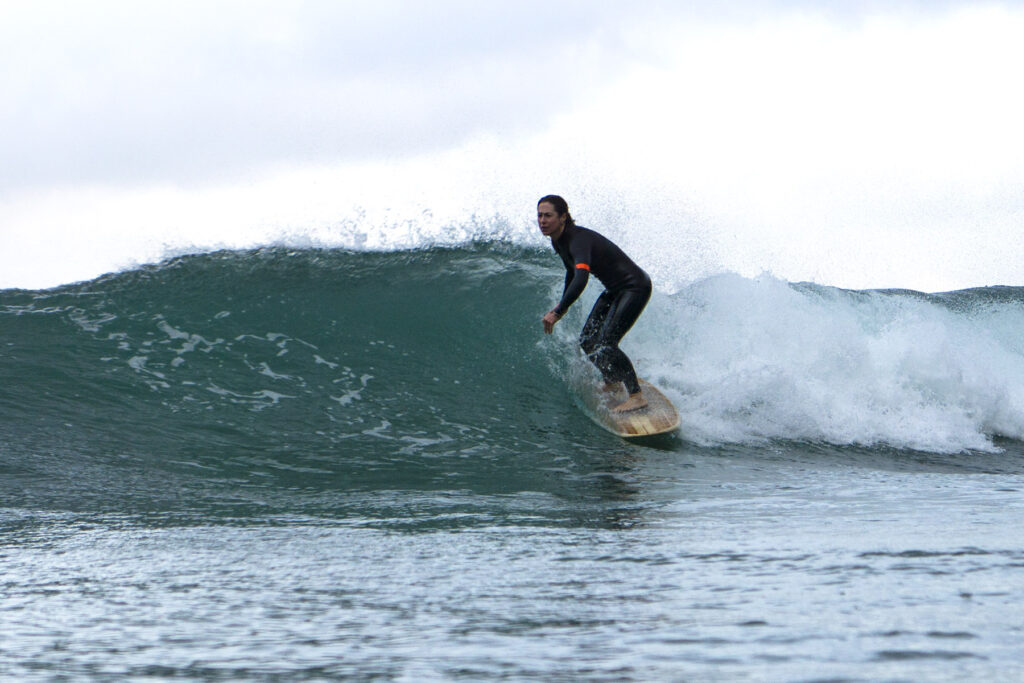 Surfing a hollow wooden surfboard, by Otter Surfboards