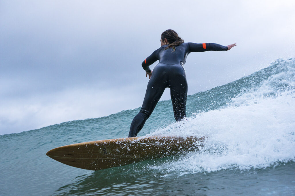 Surfing a hollow wooden surfboard, by Otter Surfboards