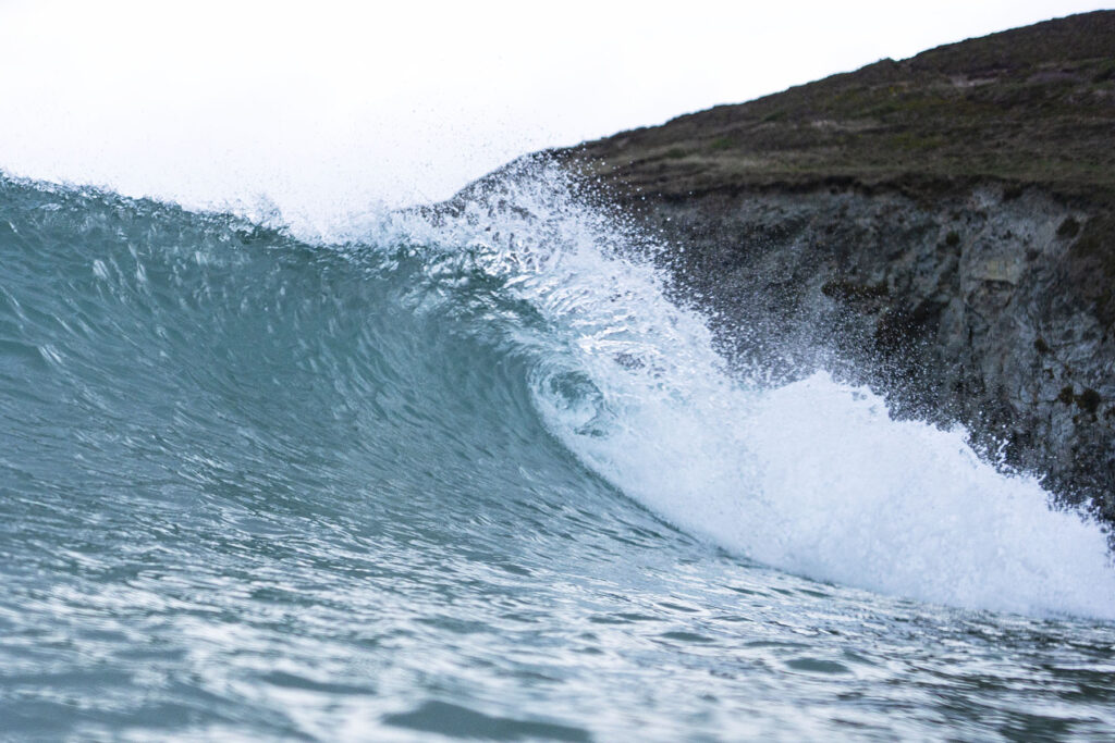 Surfing a hollow wooden surfboard, by Otter Surfboards